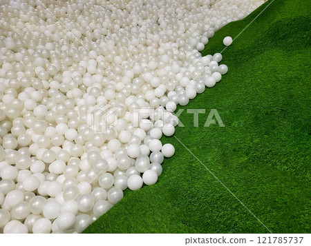 Background of white plastic balls on a green artificial grass field Background of white plastic balls on a green artificial grass field 121785737