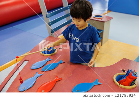 A boy playing with a toy 121785924