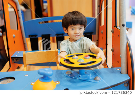 A boy playing with a toy 121786340