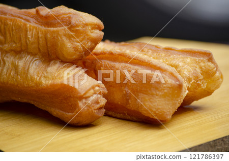 Close up of cakoi or youtiao cake. Asian food concept. Close up of cakoi or youtiao cake. Asian food concept. 121786397
