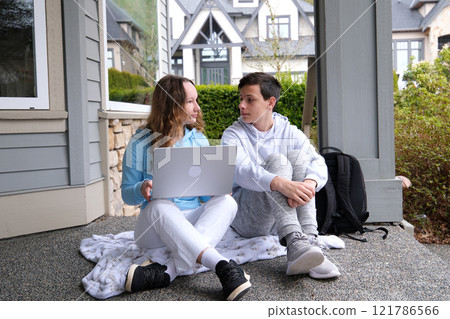 Small kid child playing on yard porch of motor wheel van home while parents working remotely with laptop. Travelling trip adventures voyage by trailer 121786566