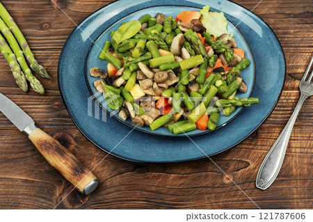 Vegan asparagus and mushroom salad. 121787606