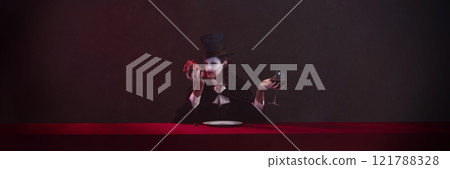 Banner. Vampire dressed in black cloak and top hat holds heart in one hand, inspecting it closely, while holding glass of red wine in other hand. Banner. Vampire dressed in black cloak and top hat holds heart in one hand, inspecting it closely, while holding glass of red wine in other hand. 121788328