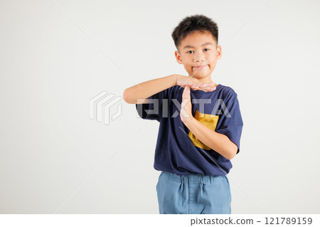 Closeup portrait young kid boy smiling making give time out gesture with hands studio shot isolated on white background, primary child demonstrates break hand sign, stop time with copy space 121789159