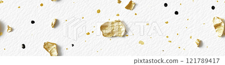 Gold and black paint splattering on white canvas background. Sprinkled gold 121789417