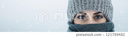 Woman wearing winter clothes protecting herself from snowfall Woman wearing winter clothes protecting herself from snowfall 121789482