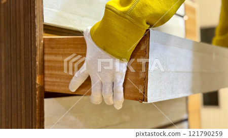 Person wearing white gloves holding a drawer Person wearing white gloves holding a drawer 121790259