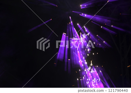 On a dark background, purple lazar rays from stage spotlights. 121790440