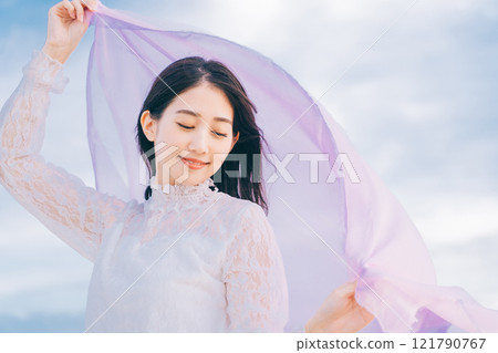 Woman portrait on blue sky background 121790767