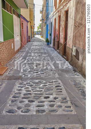 City street view of residential houses or buildings in leading alleyway in Santa Cruz, La Palma, Spain. Historical spanish and colonial architecture in tropical village and famous tourism destination City street view of residential houses or buildings in leading alleyway in Santa Cruz, La Palma, Spain. Historical spanish and colonial architecture in tropical village and famous tourism destination 121790803
