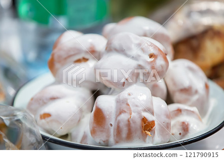 Yeast buns covered with white sugar glaze. Yeast buns covered with white sugar glaze. 121790915