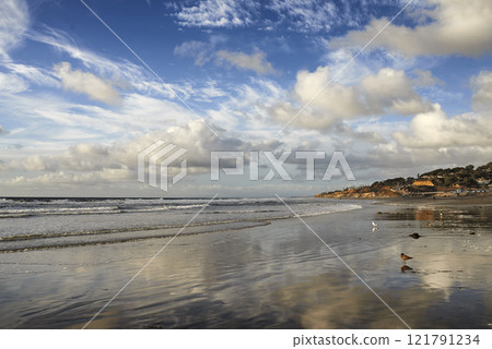 Stunning beach landscape of the sea on a cloudy day with copy space. Calm waves at the shore on a quiet coastline with peaceful blue horizon. Scenic nature at travel location in San Diego, California 121791234