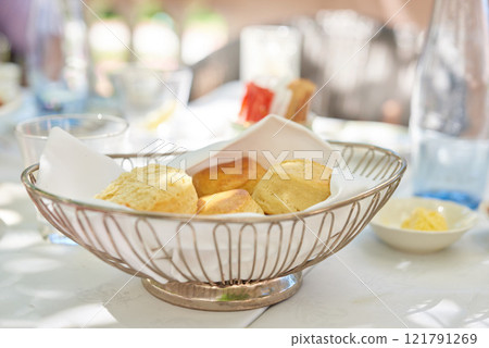 Fresh baked scones on a kitchen table at a party or event. A serving of a fresh homemade sweet snacks ready to be eaten at a family lunch. Prepared cakes for guests at a lunch date or function 121791269