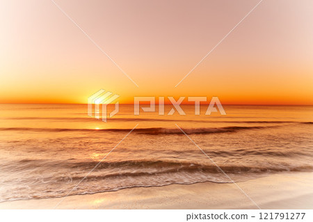 Landscape and sunset view of an empty beach or ocean at dusk in the evening. Seascape with copy space of a golden sun setting over the horizon on the west coast of Jutland in Loekken, Denmark 121791277