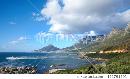 A beautiful sea landscape near a mountain with lush green plants growing outdoors in nature. Peaceful and scenic view of the ocean or beach with copy space on a summer afternoon A beautiful sea landscape near a mountain with lush green plants growing outdoors in nature. Peaceful and scenic view of the ocean or beach with copy space on a summer afternoon 121791291