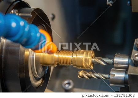 Close up scene multi-tasking CNC lathe machine swiss type hole drilling process the brass coupling parts. Close up scene multi-tasking CNC lathe machine swiss type hole drilling process the brass coupling parts. 121791308