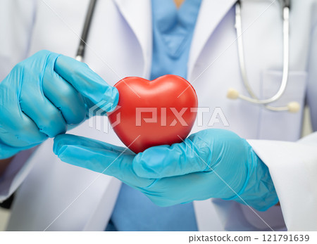 Asian woman doctor holding red heart for health in hospital. 121791639