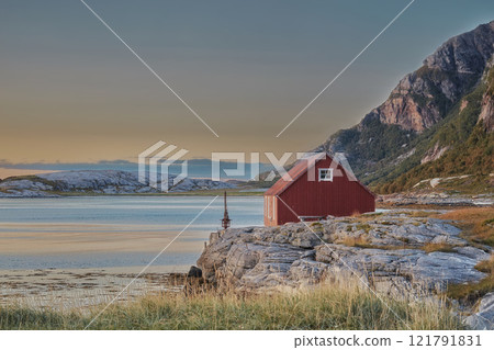 Scenic view of abandoned lake house or cabin in a remote and rocky countryside. Natural wilderness around a small bay of water in Norway. Landscape and seascape of an ocean or sea with blue sky Scenic view of abandoned lake house or cabin in a remote and rocky countryside. Natural wilderness around a small bay of water in Norway. Landscape and seascape of an ocean or sea with blue sky 121791831