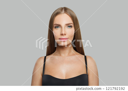 Calm young woman model with modern make-up and long straight smooth hairstyle standing Calm young woman model with modern make-up and long straight smooth hairstyle standing 121792192
