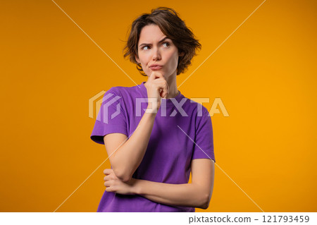 Thinking around stylish woman on yellow background. Puzzled lady looking answer Thinking around stylish woman on yellow background. Puzzled lady looking answer 121793459