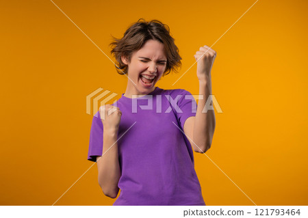 Happy pretty woman shows triumph yes victory gesture, she won jackpot, lottery 121793464