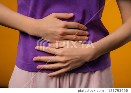 Young woman squeezing belly with hands. abdominal pain, suffering stomach ache Young woman squeezing belly with hands. abdominal pain, suffering stomach ache 121793466