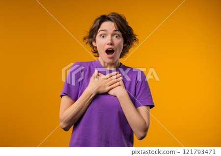 Surprised woman, she expresses WOW, cant believe. Impressed lady trying to get attention. Concept of sales, profitable offer. Excited romantic girl on yellow background Surprised woman, she expresses WOW, cant believe. Impressed lady trying to get attention. Concept of sales, profitable offer. Excited romantic girl on yellow background 121793471