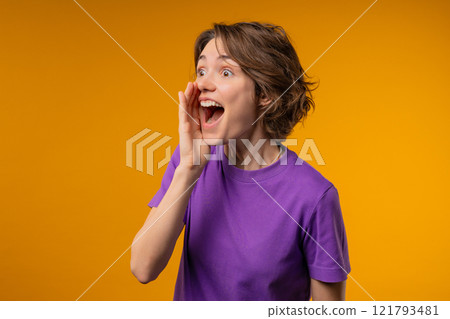 Attention, portrait of young woman shouting, holding hand near open mouth Attention, portrait of young woman shouting, holding hand near open mouth 121793481