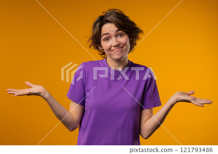 Confused pretty woman, shoulders up - can't help, makes gesture of I dont know. Difficult question, guilty reaction, puzzled stylish lady on yellow background 121793486