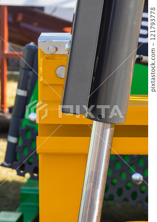 Gray pistons or actuators in yellow pneumatic or hydraulic machine. Technology Gray pistons or actuators in yellow pneumatic or hydraulic machine. Technology 121793778