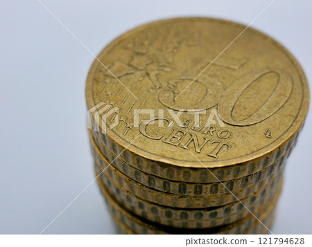 A stack of 50 euro cent coins close up on a white background with copy space. Saving, casino, economy and investment concept 121794628
