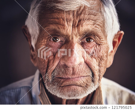 Old grumpy wrinkled man looking at camera 121795025