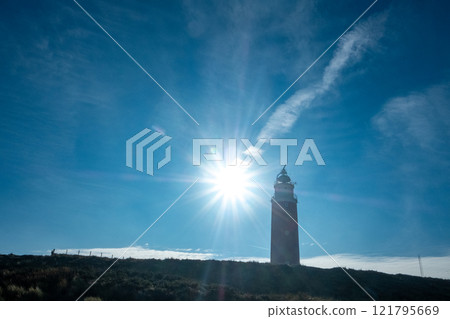 Eierland, De Cocksdorp, Texel, The Netherlands, Oktober 28th, 2024, A lighthouse silhouette stands Eierland, De Cocksdorp, Texel, The Netherlands, Oktober 28th, 2024, A lighthouse silhouette stands 121795669