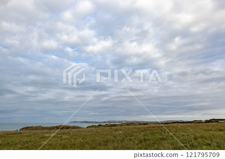 Serene Coastal Landscape invites peace, blending natures beauty with expansive horizon 121795709