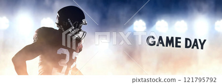 American Football player in helmet standing on field with stadium lights, game day text 121795792