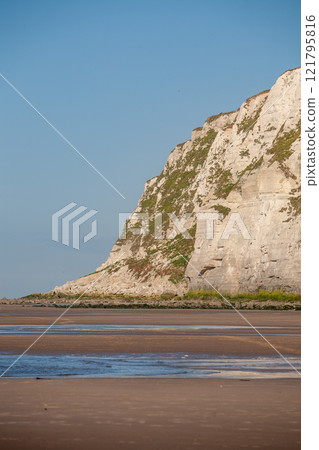 Stunning Serene Coastal Cliffs Stand Majestically Against a Brilliantly Clear Blue Sky Stunning Serene Coastal Cliffs Stand Majestically Against a Brilliantly Clear Blue Sky 121795816