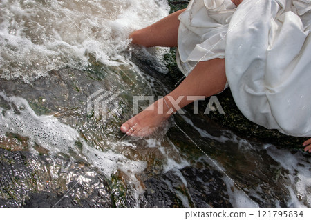 Experience the Bridal Feet by the Water Cherishing Elegant Moments Immersed in Natures Beauty 121795834