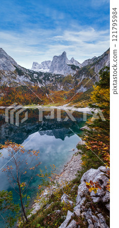 Picturesque Hinterer Gosausee lake, Upper Austria. Autumn Alps mountain lake with clear transparent water and reflections. Dachstein summit and glacier in far. 121795984