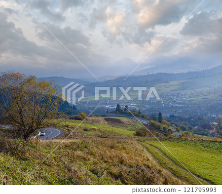 Hazy and overcast Carpathian Mountains and highway serpentine on mountain pass, Ukraine. Hazy and overcast Carpathian Mountains and highway serpentine on mountain pass, Ukraine. 121795993