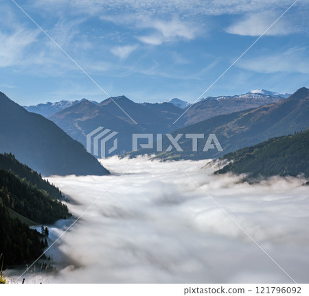 Peaceful misty autumn morning mountain view from hiking path near Dorfgastein, Austria. 121796092