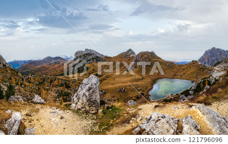 Overcast morning autumn alpine Dolomites mountain scene. Peaceful Valparola Path and Lake view, Belluno, Italy. 121796096