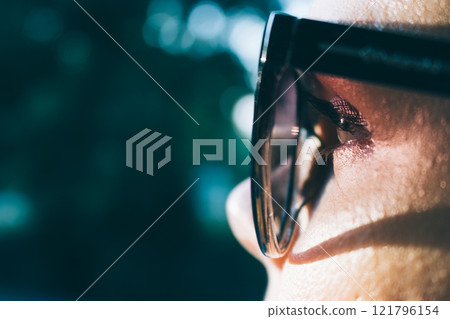 A woman wearing sunglasses A woman wearing sunglasses 121796154