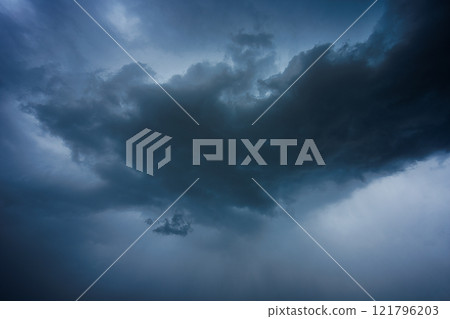 Dramatic storm clouds in blue sky associated with storm, dark, moody weather and looming atmosphere Dramatic storm clouds in blue sky associated with storm, dark, moody weather and looming atmosphere 121796203