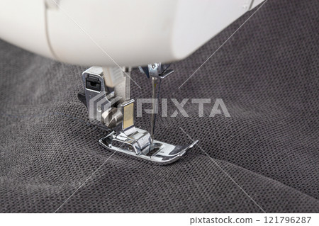 Sewing machine, stitching fabrics, needle in a round plan Sewing machine, stitching fabrics, needle in a round plan 121796287