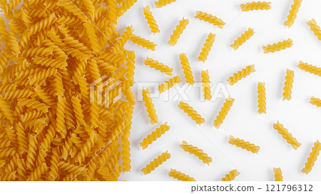 Pasta products in the form of a spiral, texture, on a white background 121796312