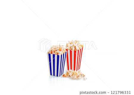 Glass with popcorn on a white background 121796331