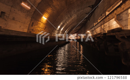 Dark concrete tunnel perspective with neon lights illumination 121796588