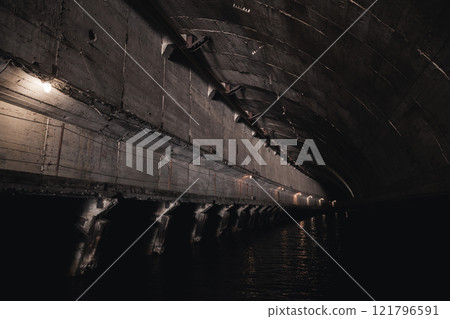 Dark industrial concrete tunnel perspective 121796591