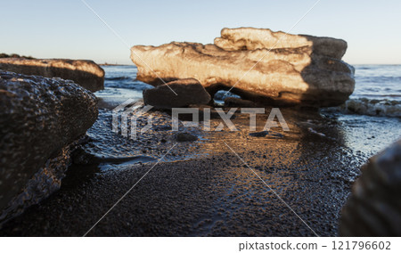 Dirty melting ice floes lay on the coast of Baltic Sea, 121796602