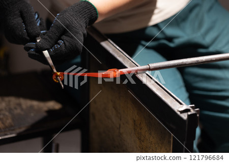 Molten glass sculpting, works of a glass blowing workshop Molten glass sculpting, works of a glass blowing workshop 121796684